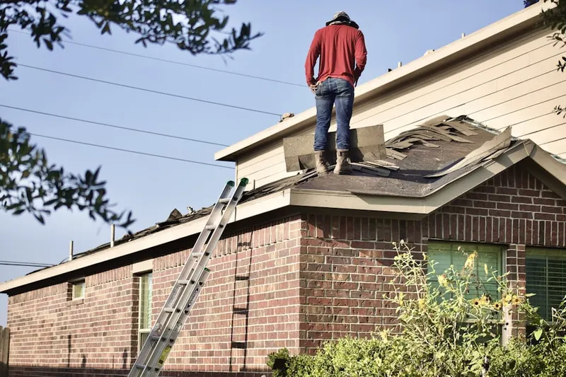 Professional roofer working on a residential roof in Pioneer Protectors